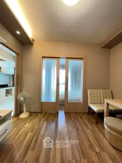 Modern living room with wooden flooring and frosted glass doors