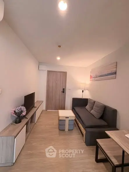 Modern living room with sleek furniture and stylish decor in a cozy apartment setting.