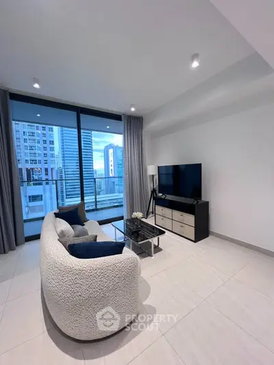 Modern living room with city view, featuring sleek furniture and large windows.