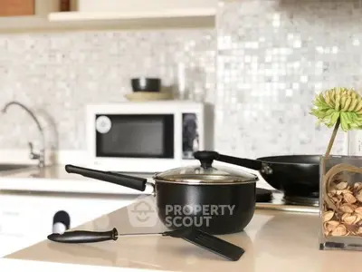 Modern kitchen with sleek appliances and stylish backsplash, perfect for culinary enthusiasts.