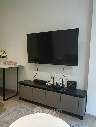 Modern living room with wall-mounted TV and sleek console table