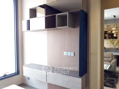 Modern interior with stylish shelving and elegant lighting in a contemporary apartment.
