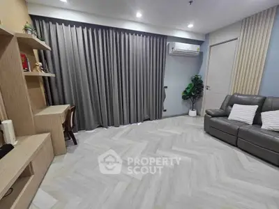 Spacious modern living room with elegant flooring and cozy seating area.
