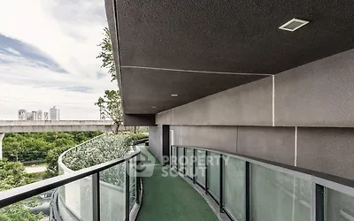 Modern curved balcony with glass railing and city view