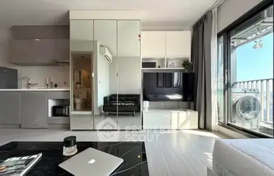 Modern studio apartment with sleek design and balcony view