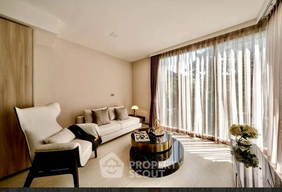 Luxurious living room with elegant decor and floor-to-ceiling windows offering abundant natural light.