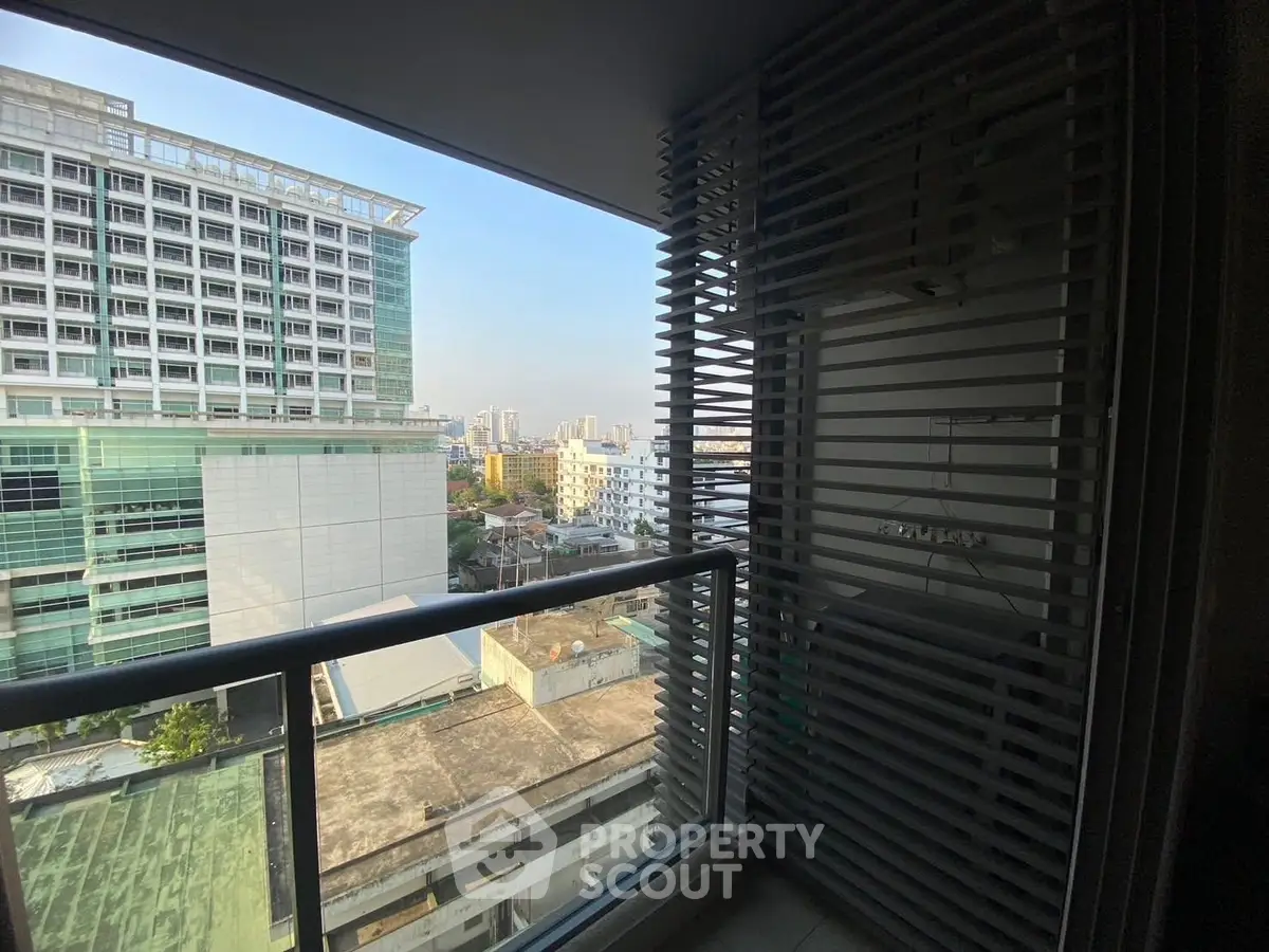 Stunning cityscape view from a modern apartment balcony with sleek railing design.