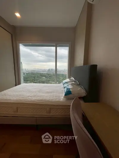 Cozy bedroom with stunning city view from large window