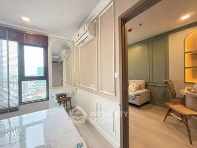 Modern apartment interior with stylish decor and city view from window.