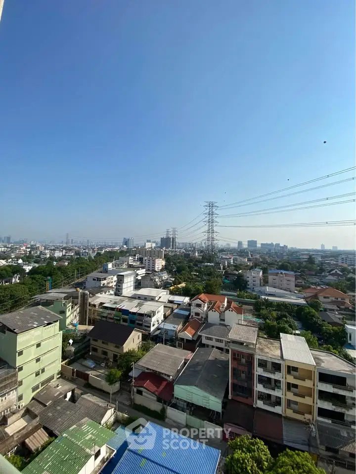 Stunning cityscape view from high-rise building showcasing urban landscape and clear blue sky.