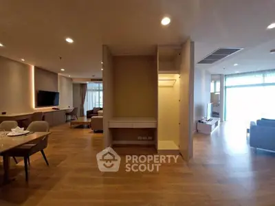 Spacious modern living room with open layout and elegant wooden flooring.