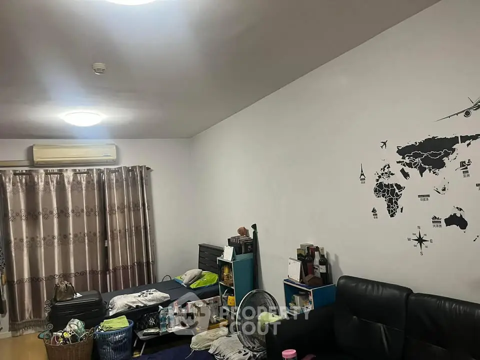Cozy living room with modern decor and wall art, featuring comfortable seating and ample natural light.