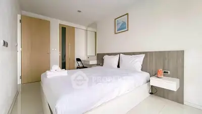 Modern minimalist bedroom with white decor and natural light