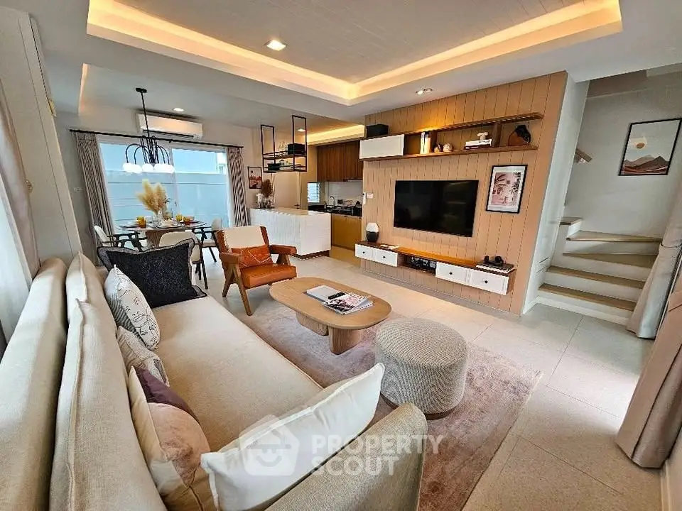 Stylish modern living room with open kitchen and cozy seating area