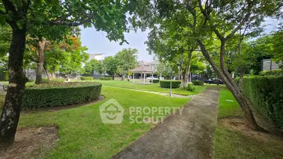 Lush green garden with pathway in a serene residential community
