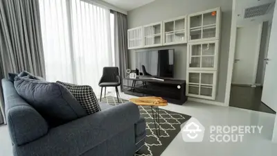 Modern living room with sleek furniture and large windows in a stylish apartment.