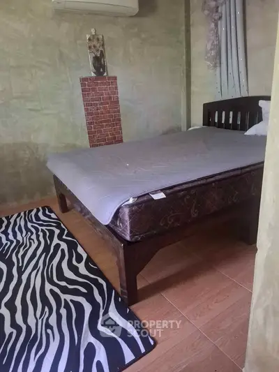 Cozy bedroom with unique decor and zebra print rug