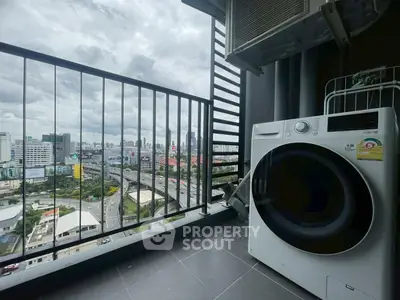 High-rise balcony with city view and modern washing machine, perfect for urban living.