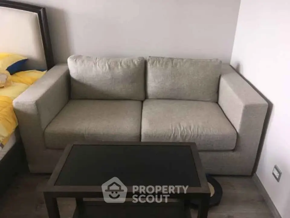 Cozy living room with modern gray sofa and sleek coffee table, perfect for relaxation.