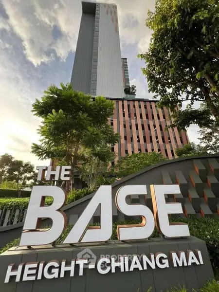 Modern high-rise building with lush greenery at The Base Height Chiang Mai.