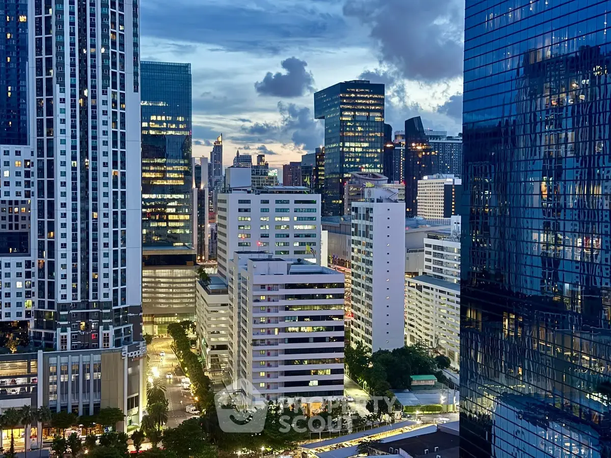 Stunning cityscape view showcasing modern skyscrapers at dusk with vibrant lights.