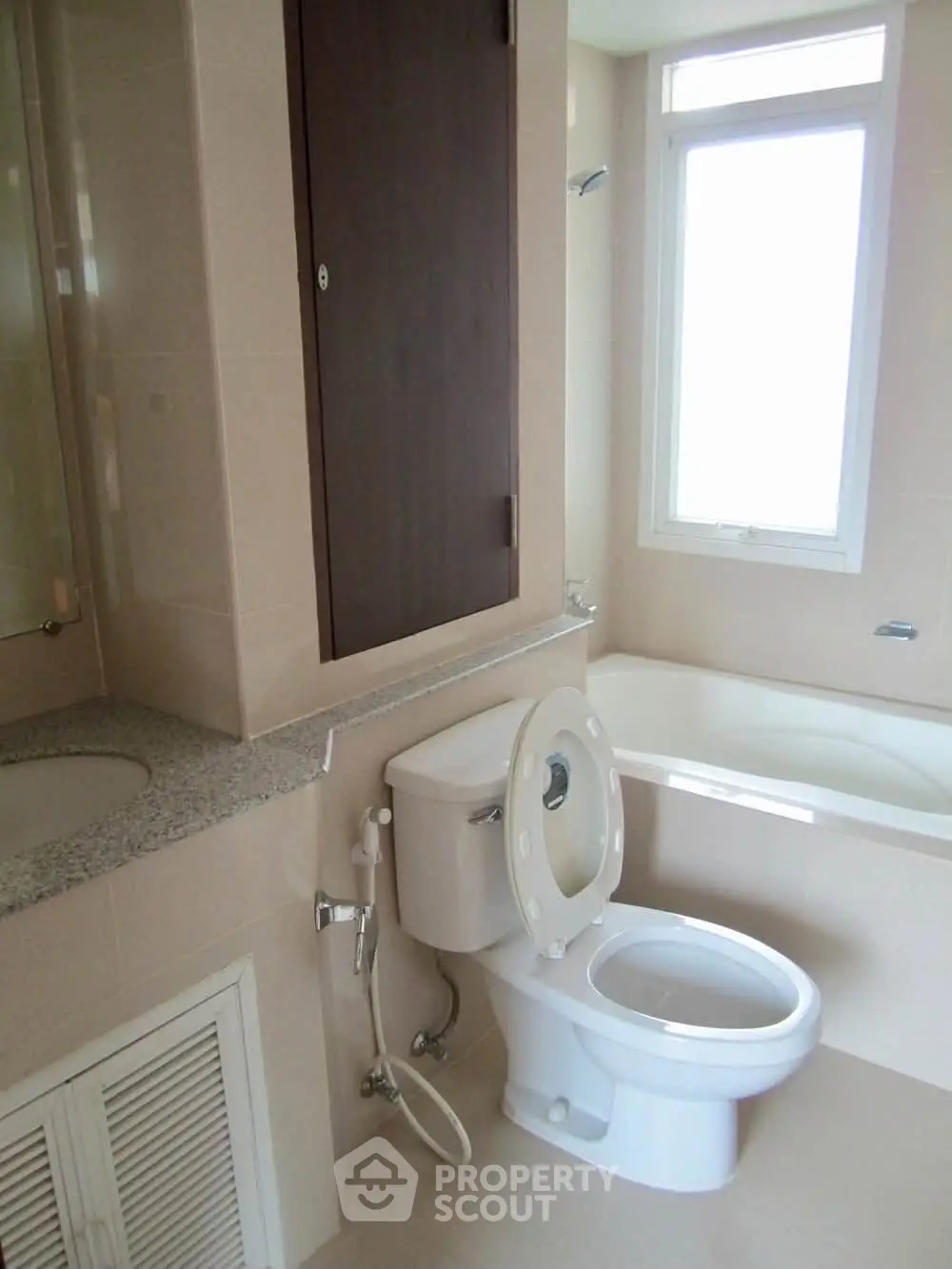 Modern bathroom with bathtub and window offering natural light