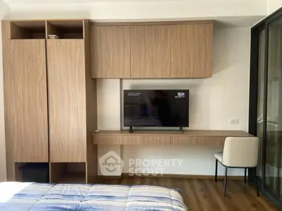 Modern bedroom with built-in wooden wardrobe and TV unit, featuring sleek design and cozy atmosphere.