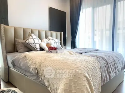 Luxurious bedroom with elegant decor and natural light from large windows.
