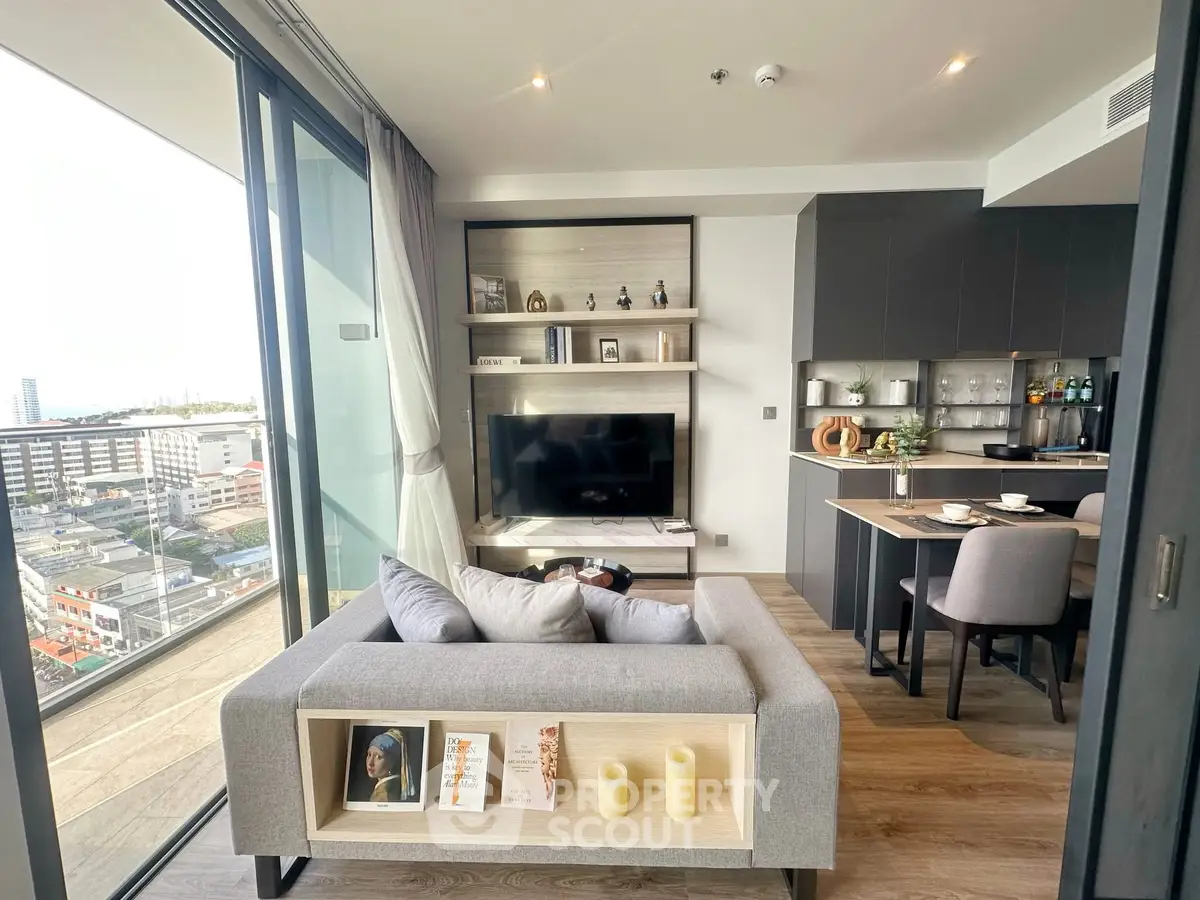 Modern living room with open kitchen and city view balcony in stylish apartment