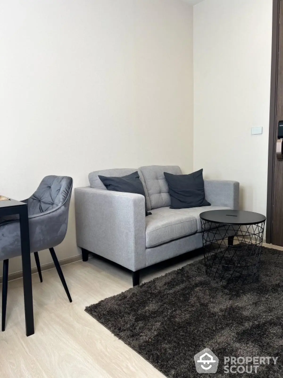 Modern living room with stylish gray sofa and chic black coffee table