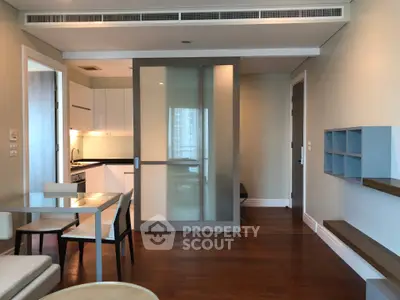 Modern apartment interior with sliding doors and open kitchen layout