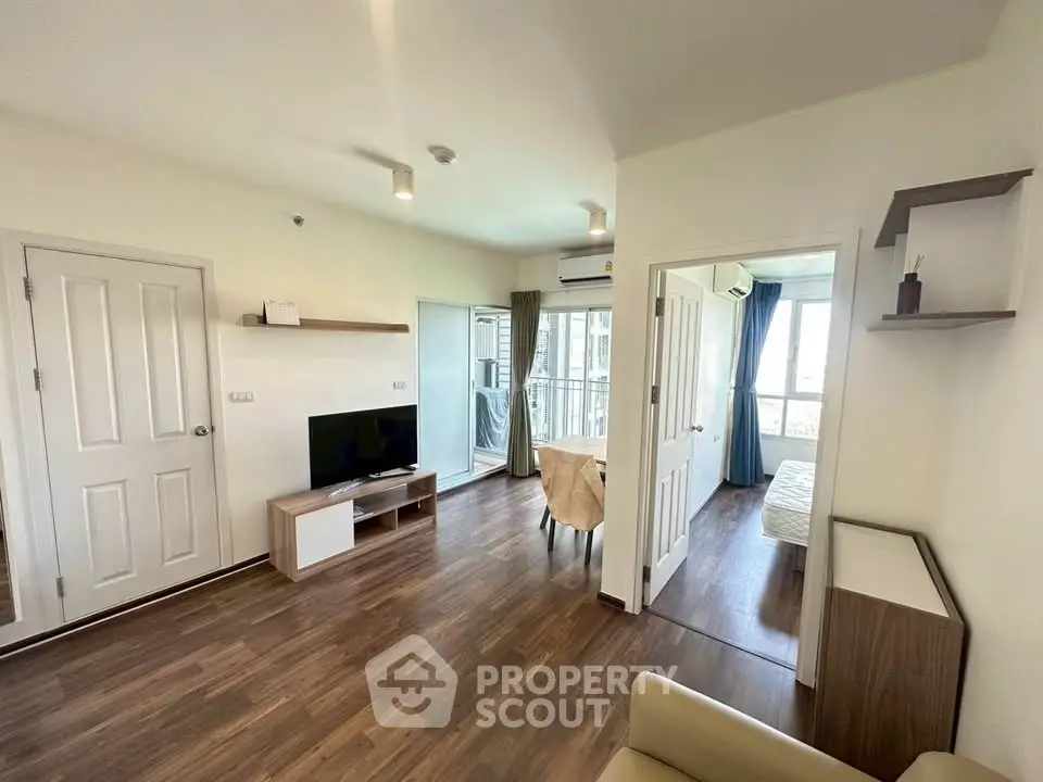 Spacious modern living room with wooden flooring and natural light