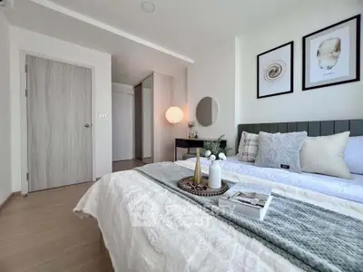 Modern bedroom with stylish decor and cozy ambiance, featuring elegant wall art and soft lighting.