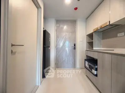 Modern kitchen with sleek cabinetry and appliances in a contemporary apartment.