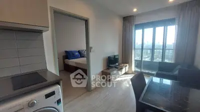Modern apartment with open layout, featuring a cozy living area, bedroom, and city view balcony.