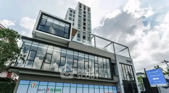 Modern commercial building with glass facade and retail space, ideal for business opportunities.