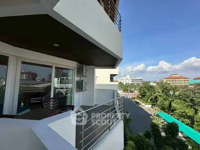 Spacious balcony with city view in modern apartment building