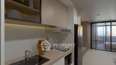 Modern kitchen with sleek appliances and open layout leading to a bright living area.