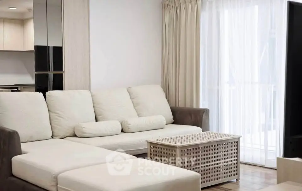 Modern living room with cozy white sofa and stylish decor in a bright apartment.