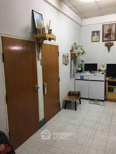 Cozy study room with wooden doors and computer setup