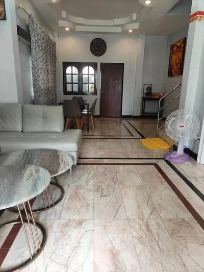 Spacious living room with elegant marble flooring and modern decor