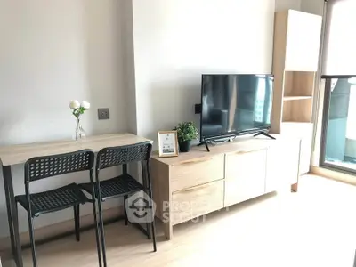 Modern living room with stylish furniture and large TV, perfect for relaxation and entertainment.