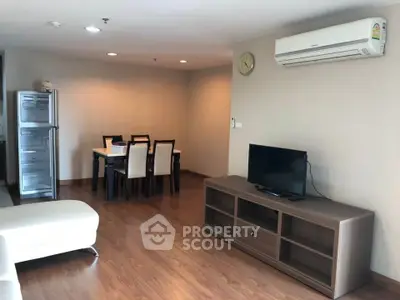 Spacious living room with modern furniture and air conditioning in a stylish apartment.