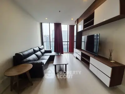 Modern living room with sleek furniture and city view, perfect for urban living.