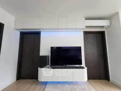 Modern living room with sleek TV setup and ambient lighting