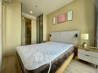 Modern bedroom with stylish decor and ample natural light, featuring a comfortable bed and elegant furnishings.