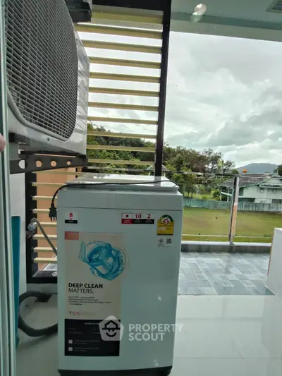 Modern balcony with washing machine and scenic view, perfect for convenient laundry days.