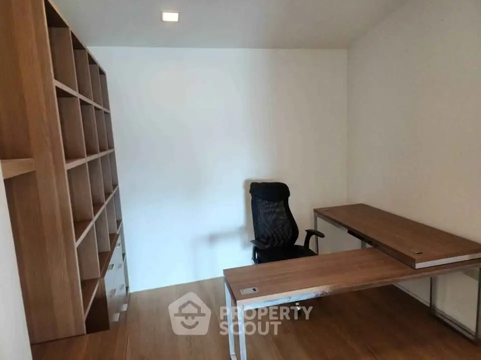Modern study room with sleek wooden desk and ergonomic chair, perfect for productivity.