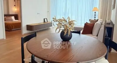 Elegant open-plan living and dining area with modern decor and natural light.
