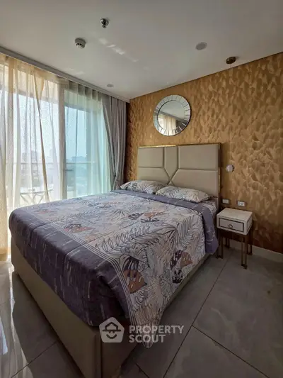 Luxurious bedroom with elegant decor and large window offering natural light